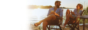 Couple sitting on the dock and sharing a joke