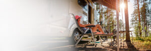 Woman relaxing in a lawn chair in front of her RV