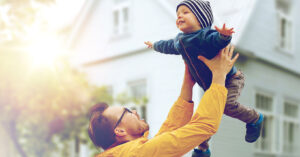 Dad tossing his baby son in the air