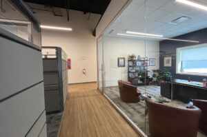 Interior of McLean & Dickey office space with glass walled office