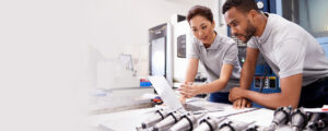 two engineers examining parts in a lab