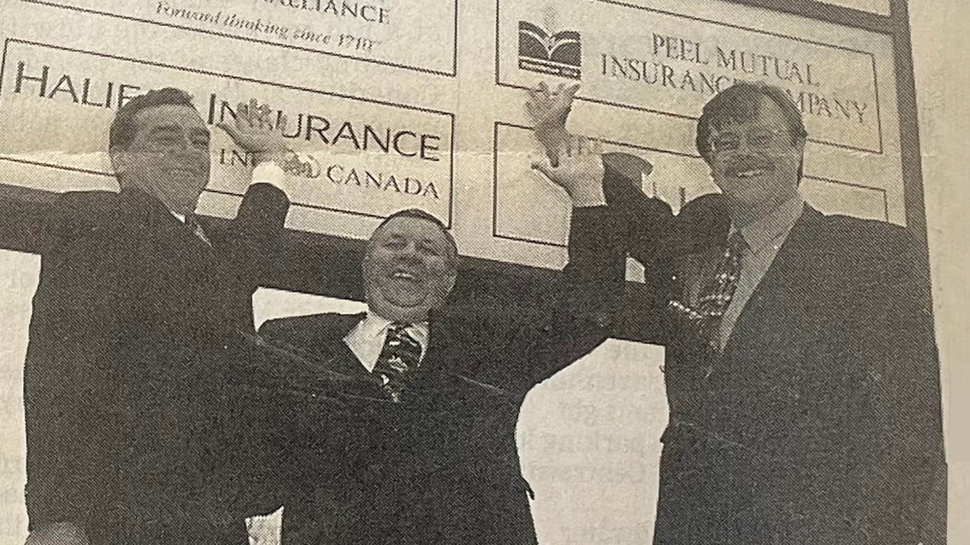 Bill Hamilton, Wayne Macintosh and Bill Adams in front of Laclie Street office sign