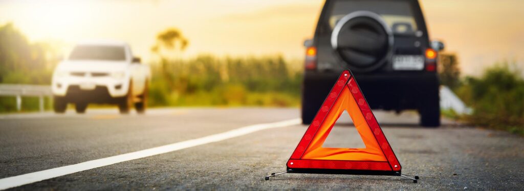 Safety triangle on road behind stopped car