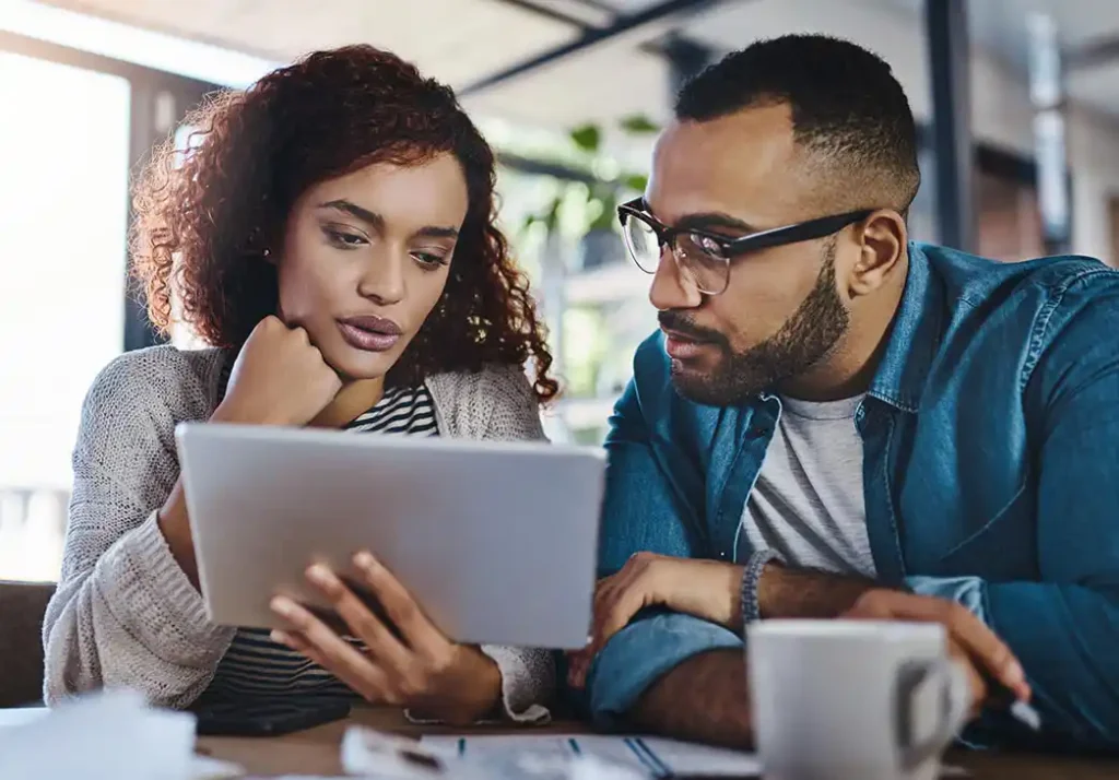 Couple reviewing their home and auto insurance on a tablet