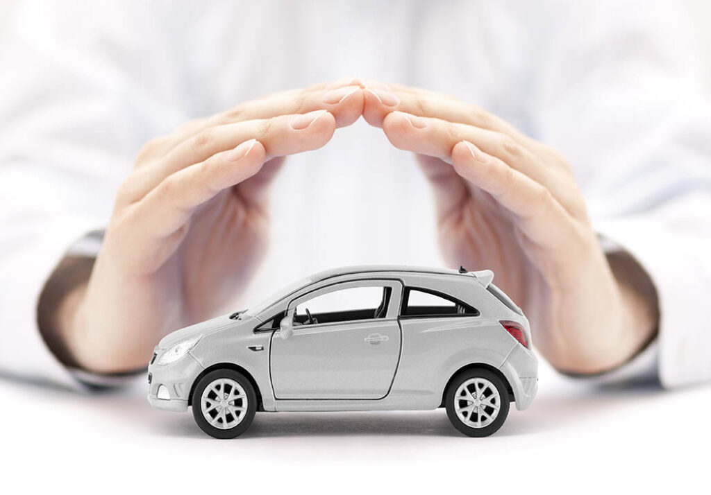 pair of hands sheltering a model car