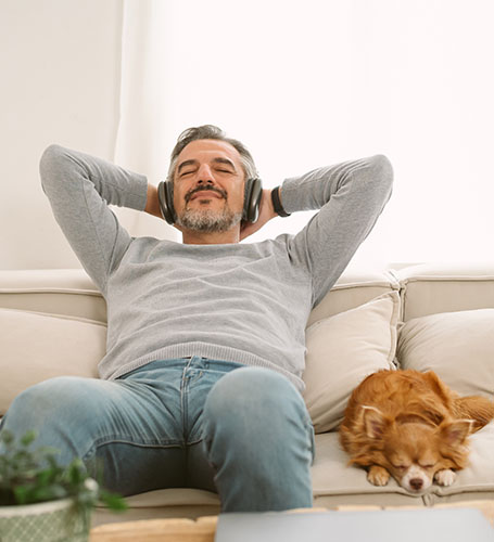 man on couch with dog