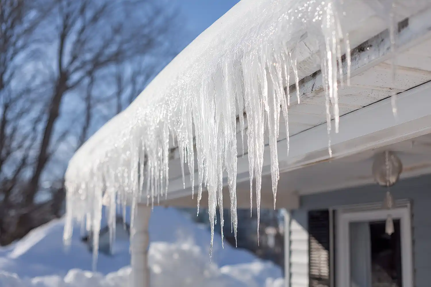 heavy snowfall and moisture accumulation on roof with icicles and deep snow
