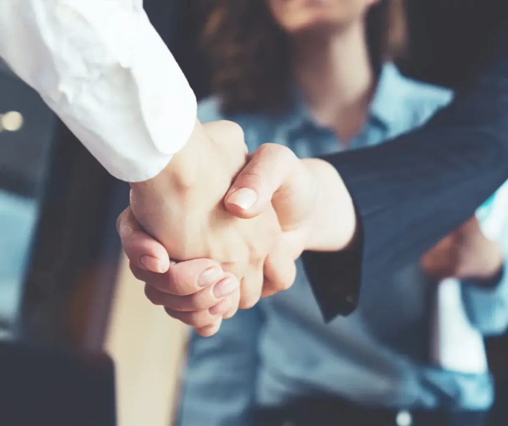 Young business people shaking hands in the office.