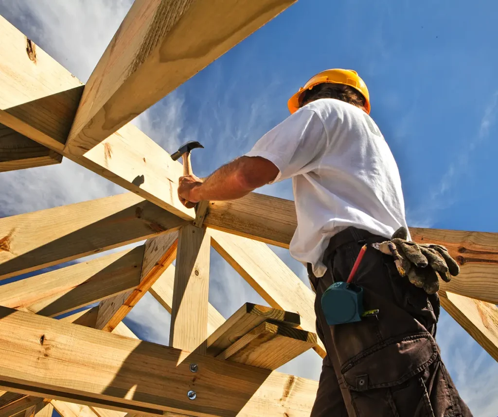 roofer ,carpenter working on roof structure at construction site