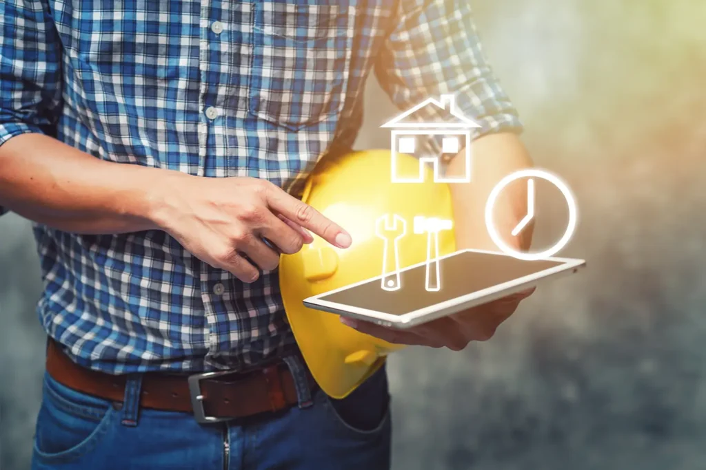 Engineer holding helmet and using tablet checking for project Construction.