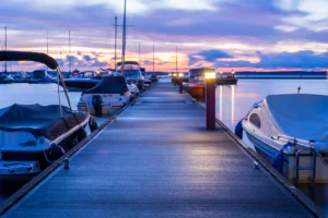 Boats parked at a marina at sunset