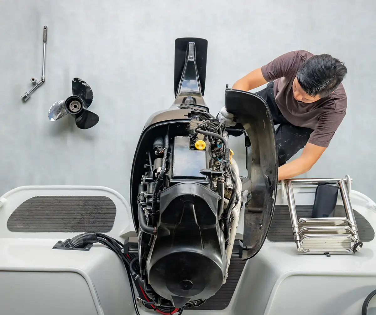Repairing engines on aluminum boats , The technician is removing the boat parts