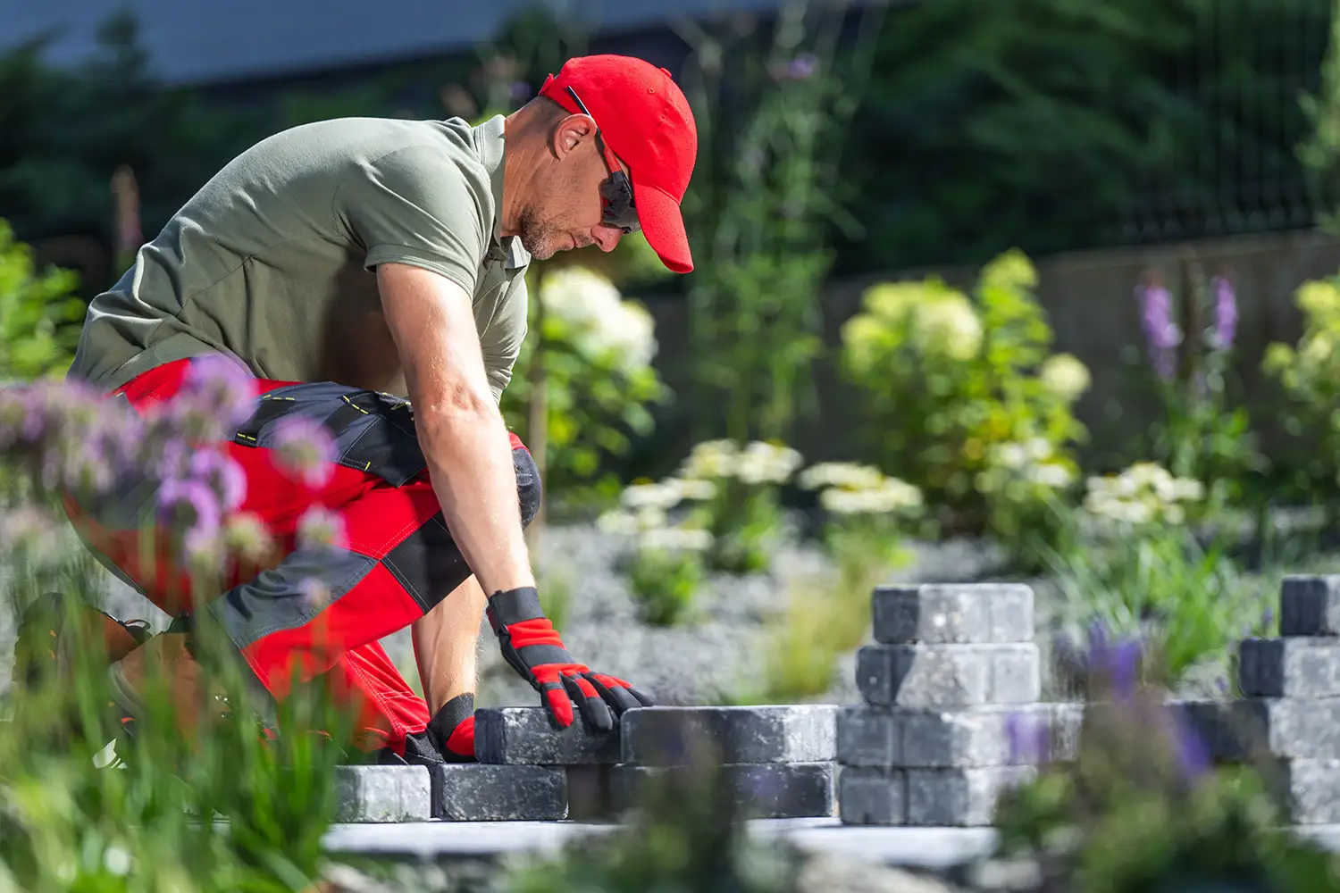 Landscaper installing paving stones in a garden
