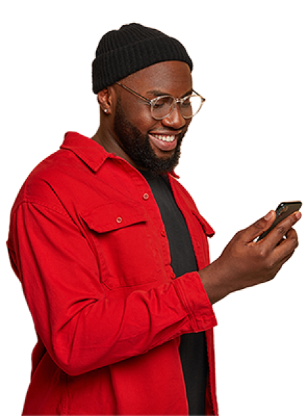 Man in red shirt looking at his mobile phone and smiling
