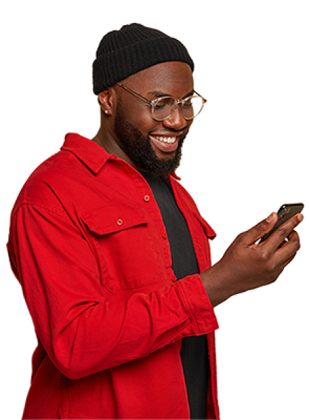 Man in red shirt looking at his mobile phone and smiling